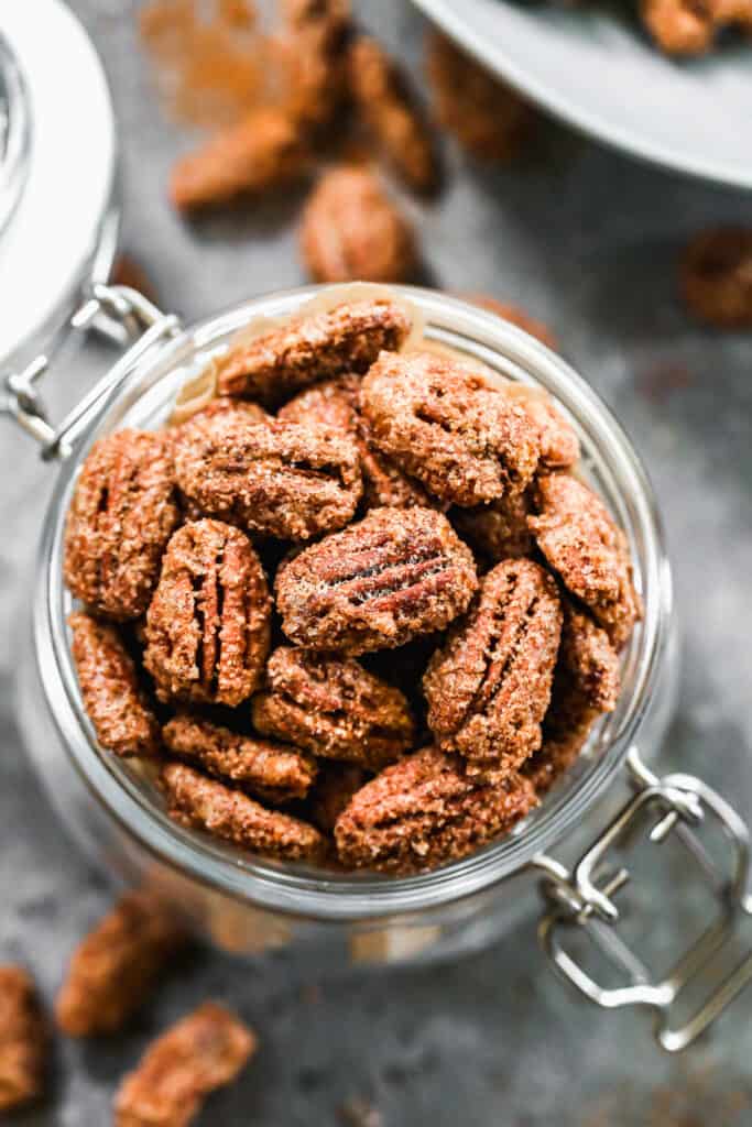 Birds eye view of candied pecans in a jar.