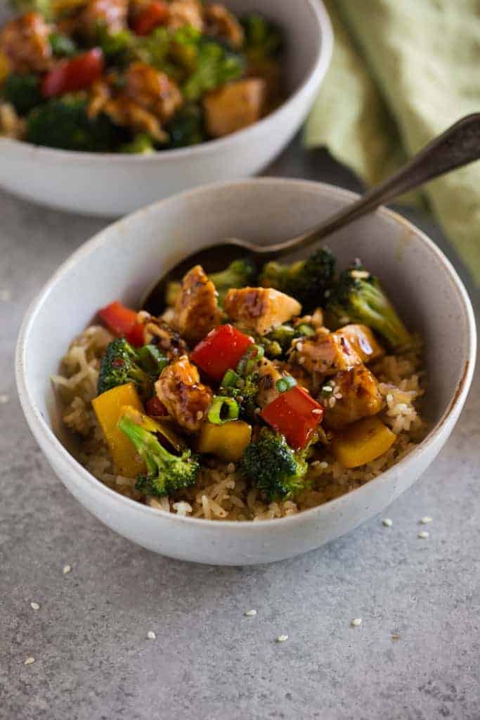 White bowl filled with Instant Pot chicken teriyaki rice and vegetables.
