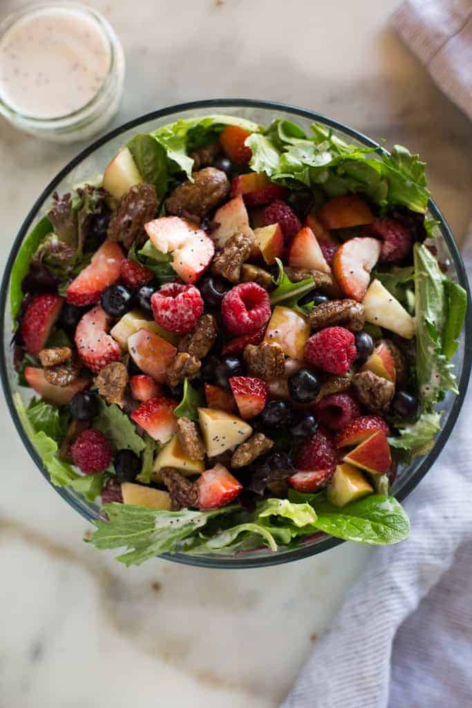 Mixed Green Salad with Berries including strawberries, blueberries and pecans and a poppyseed dressing.