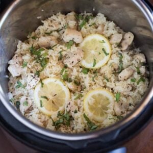 Instant Pot Lemon Basil Chicken and Rice cooked in the instant pot and then topped with fresh basil and sliced lemons.