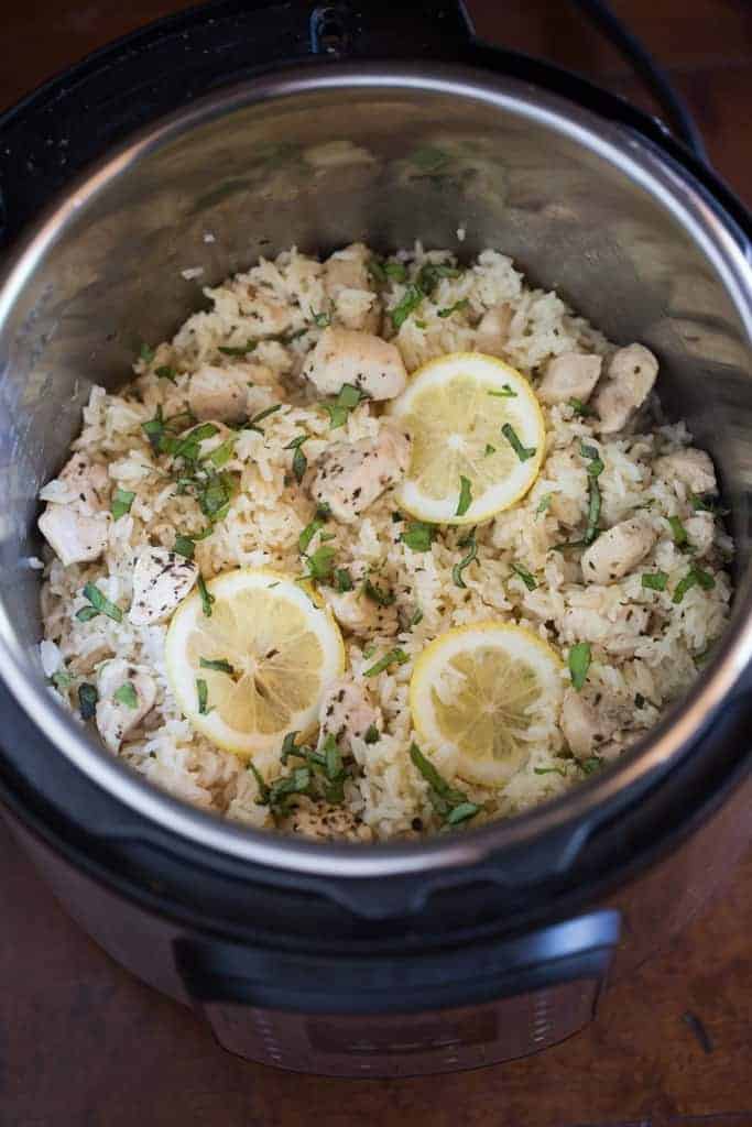 Instant Pot Lemon Basil Chicken and Rice cooked in the instant pot and then topped with fresh basil and sliced lemons.