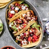 Three BBQ Chicken Tacos on an oval plate.