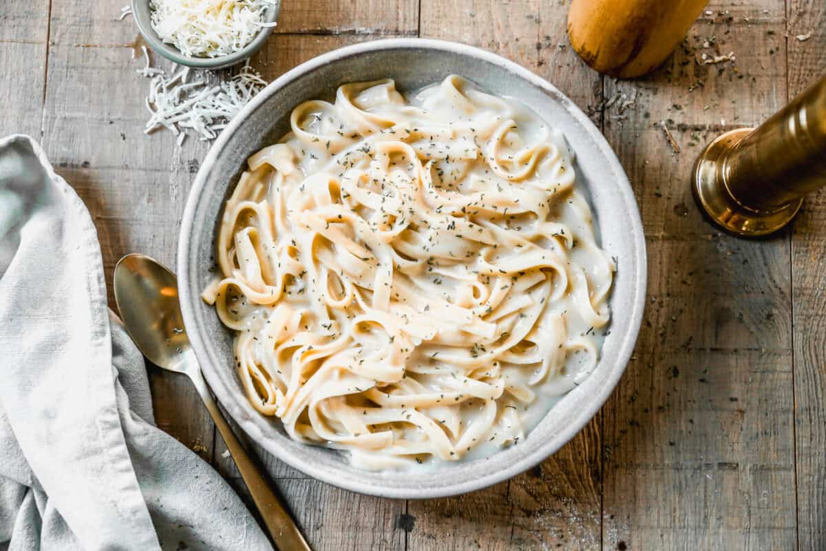 This Instant Pot Fettuccine Alfredo recipe is creamy, comforting, and half of the calories! It's a true dump it and forget it instant pot recipe that allows you to have dinner on the table in just 30 minutes!