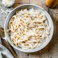 This Instant Pot Fettuccine Alfredo recipe is creamy, comforting, and half of the calories! It's a true dump it and forget it instant pot recipe that allows you to have dinner on the table in just 30 minutes!