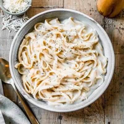 This Instant Pot Fettuccine Alfredo recipe is creamy, comforting, and half of the calories! It's a true dump it and forget it instant pot recipe that allows you to have dinner on the table in just 30 minutes!