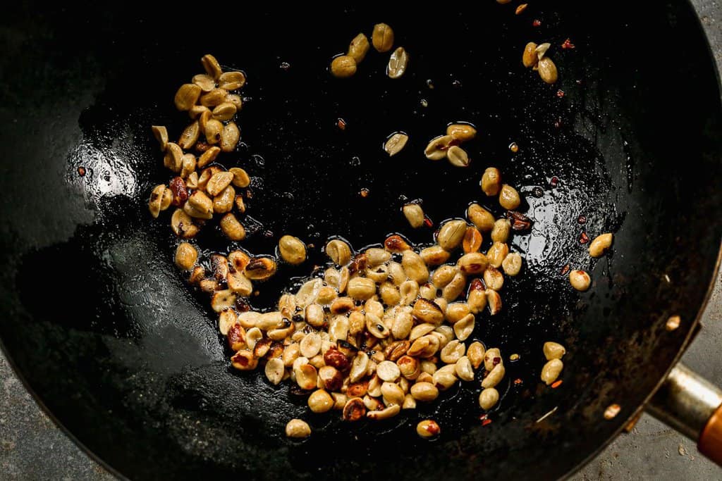 Peanut sautéing in a skillet, to make Kung Pao chicken,