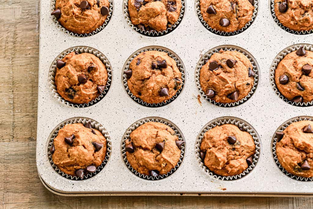 Freshly baked, healthy pumpkin muffins in a muffin tin.