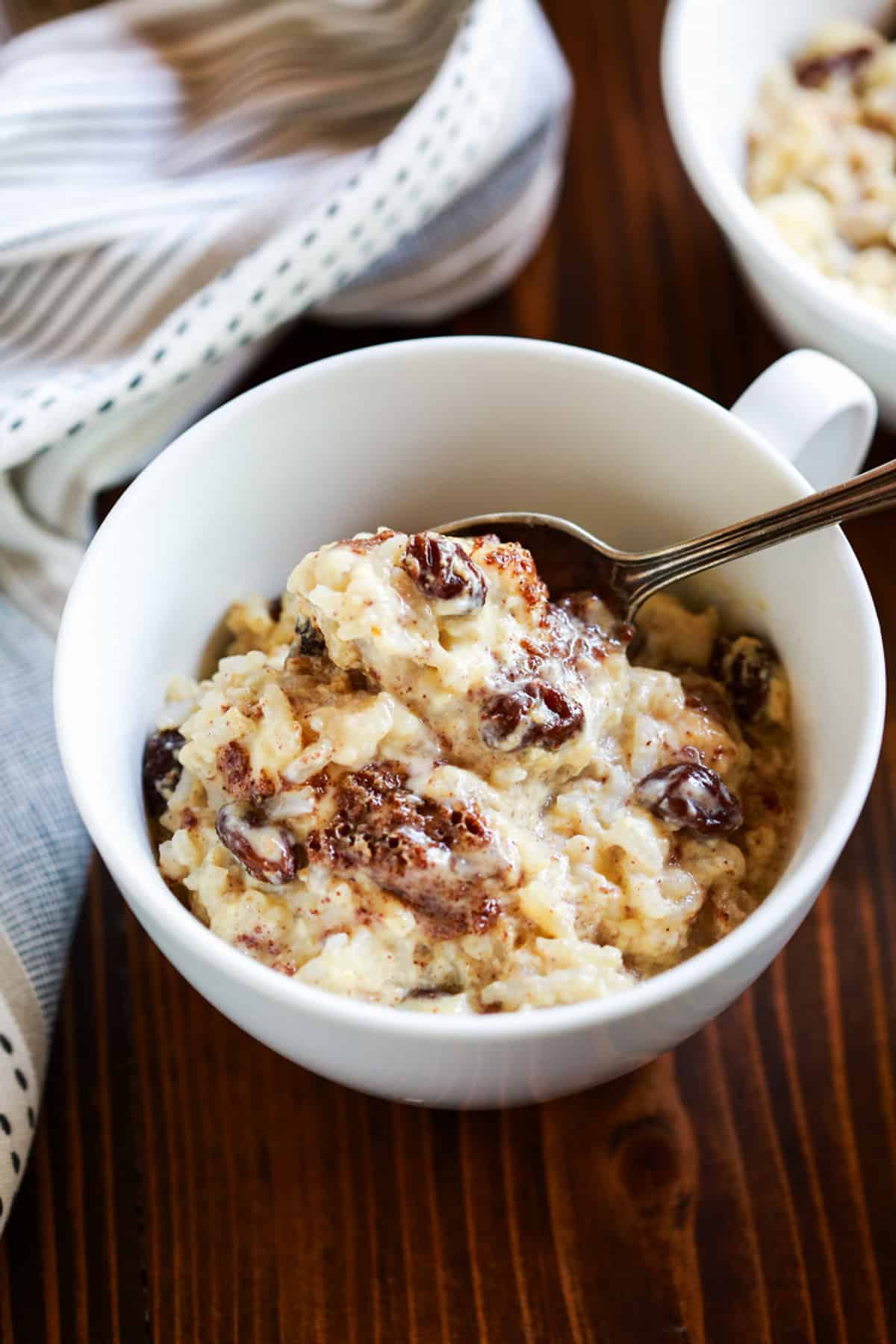This baked rice pudding recipe is easy and inexpensive to make with just a handful of pantry ingredients. It transforms leftover rice to a delicious and comforting dessert!