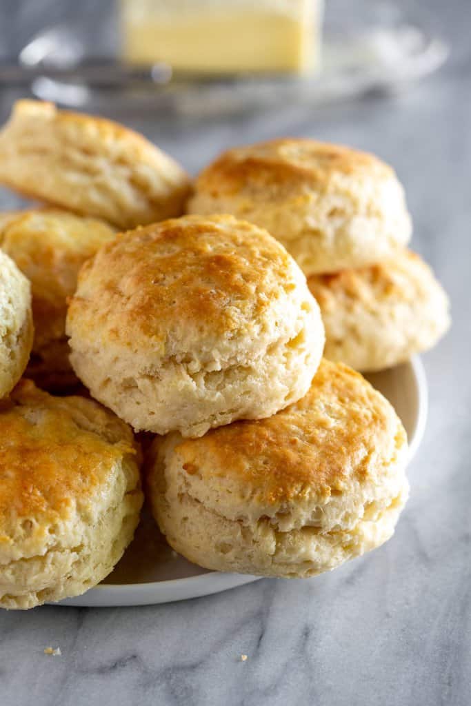 Buttermilk Biscuits freshly baked, stacked on a plate.