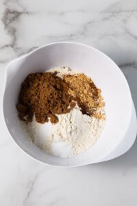 Flour and gingerbread spices in a mixing bowl.