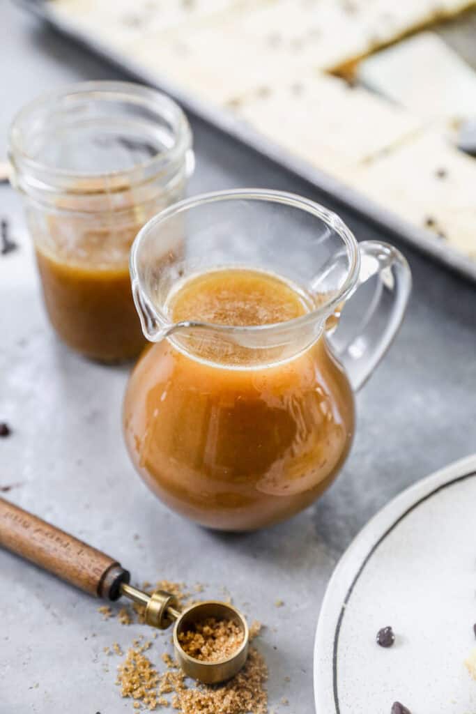 A small pitcher filled with buttermilk syrup, ready to enjoy over pancakes.