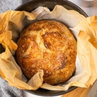 This no knead Artisan Bread recipe only requires 4 pantry staples and takes 5 minutes of prep to get a beautiful golden, crusty loaf of bread with a soft interior.