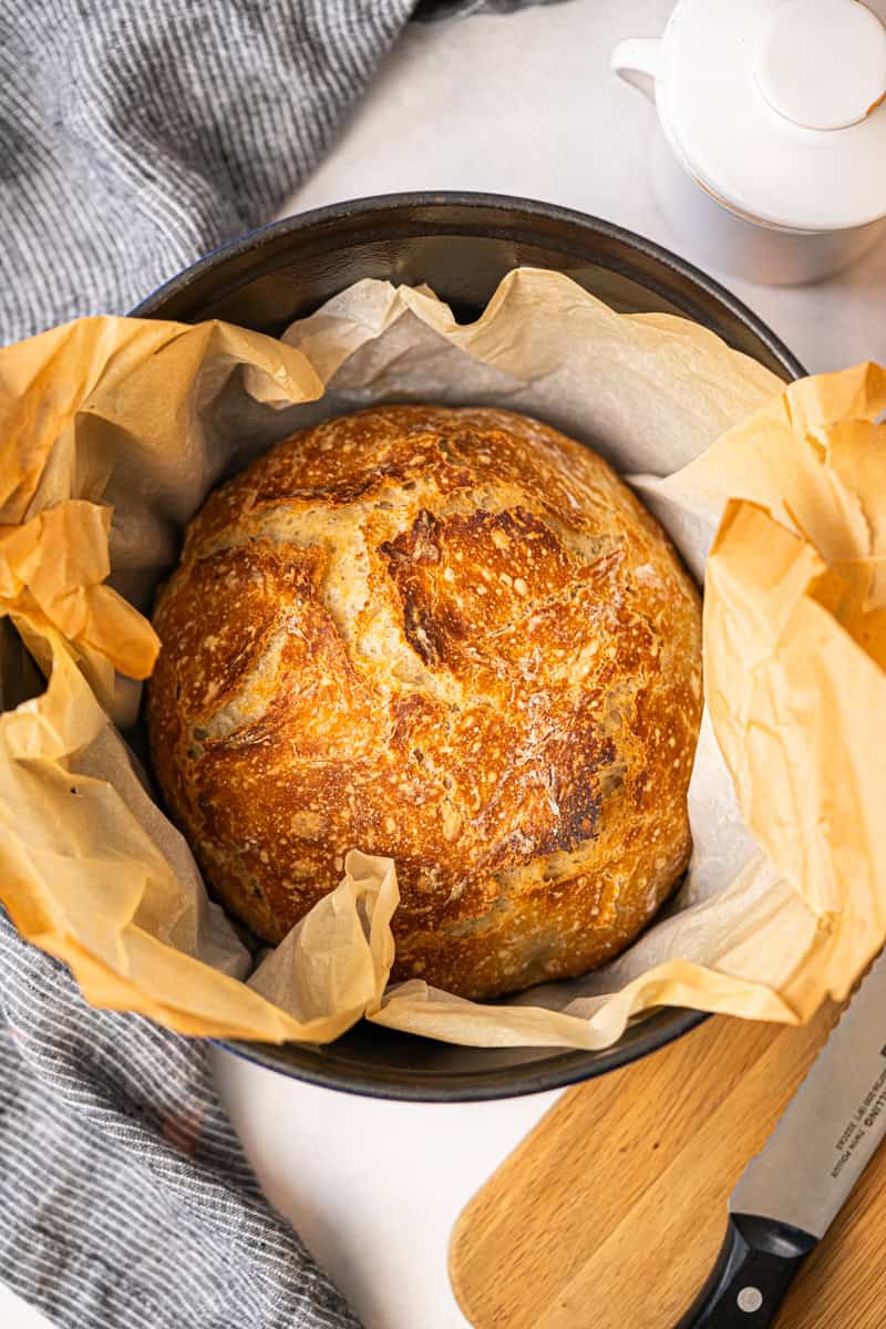 This no knead Artisan Bread recipe only requires 4 pantry staples and takes 5 minutes of prep to get a beautiful golden, crusty loaf of bread with a soft interior.