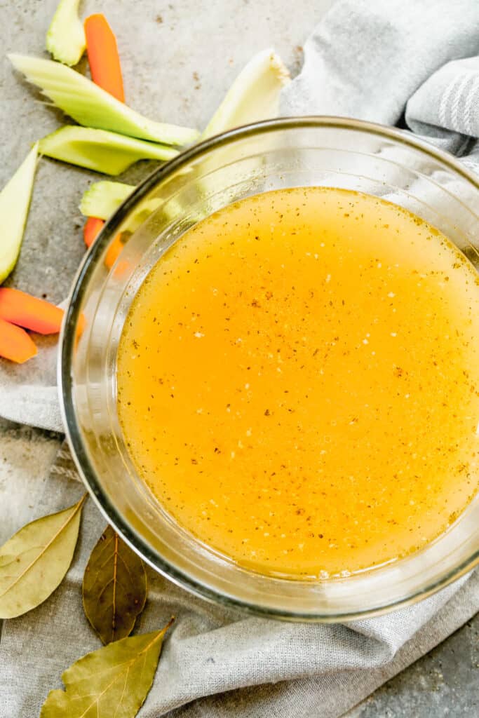 A bowl with homemade chicken stock in it.
