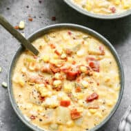 Corn chowder in a bowl with a spoon.