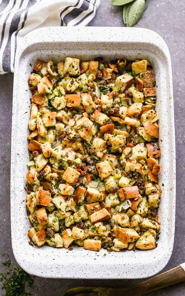 Overhead photo of white casserole dish with sausage stuffing baked in it.