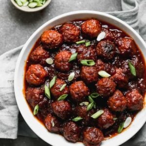 BBQ Meatballs appetizer served in a bowl garnished with green onion.