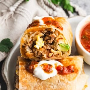 This easy Breakfast Burritos recipe is made with fluffy eggs, flavorful sausage, and crispy hashbrowns. It's perfect for making a big batch for breakfast burrito meal prep and enjoying them on-the-go all month long!