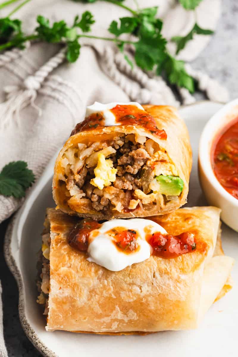 This easy Breakfast Burritos recipe is made with fluffy eggs, flavorful sausage, and crispy hashbrowns. It's perfect for making a big batch for breakfast burrito meal prep and enjoying them on-the-go all month long!