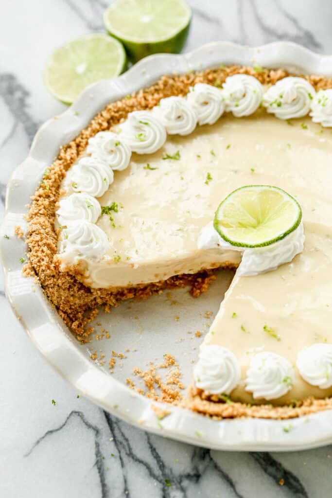 Homemade Key Lime Pie with one slice removed. 