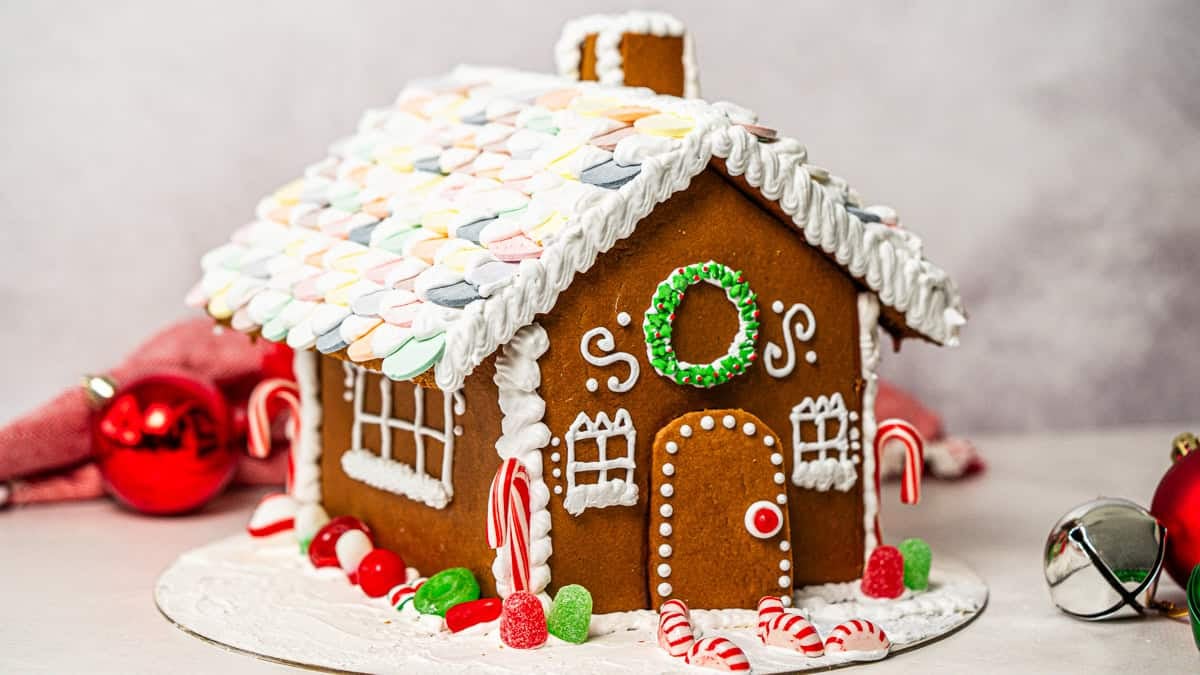 This easy Gingerbread House recipe includes a free template and step-by-step instructions! It's a fun family tradition that will make your house smell incredible and can be preserved for years to come. 