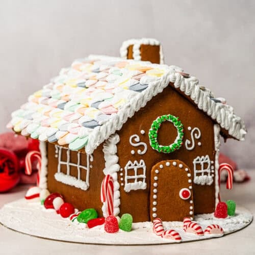 This easy Gingerbread House recipe includes a free template and step-by-step instructions! It's a fun family tradition that will make your house smell incredible and can be preserved for years to come.