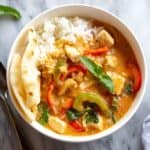 Panang Curry in a bowl with white rice and naan bread.