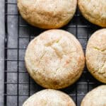 The best Snickerdoodle recipe cooling on a black cooling rack. Soft, chewy, and ready to be eaten.