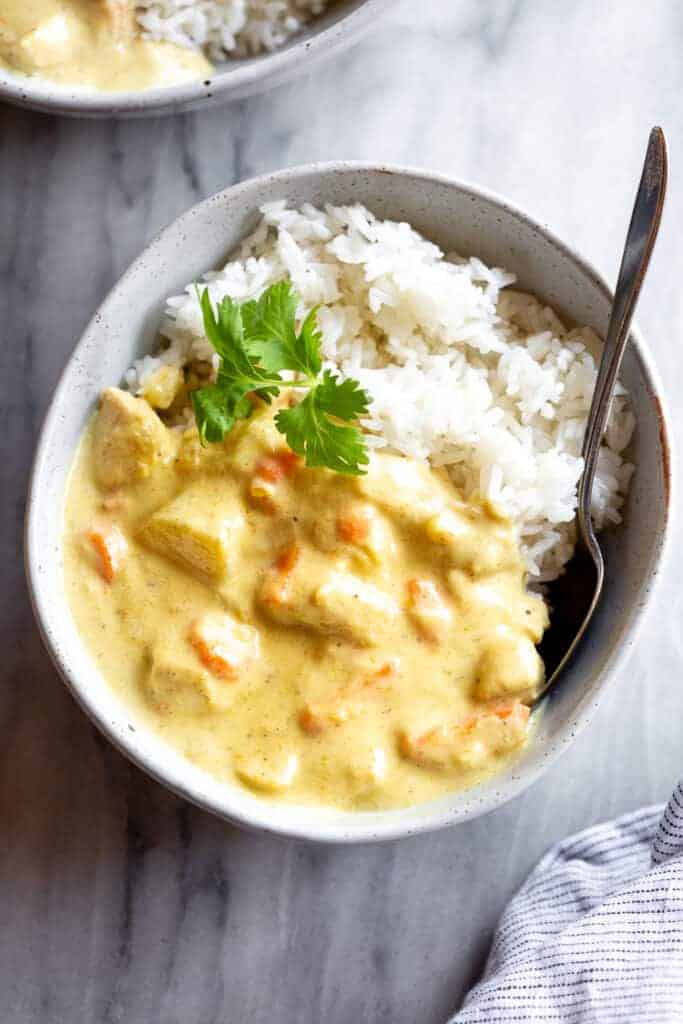 Thai yellow curry in a bowl with white rice.