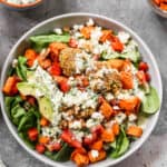 A Buddha Bowl with quinoa, spinach, falafel and veggies.