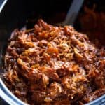 Shredded pork with red chili sauce in a slow cooker.