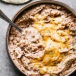 Refried beans with melted cheese on top.
