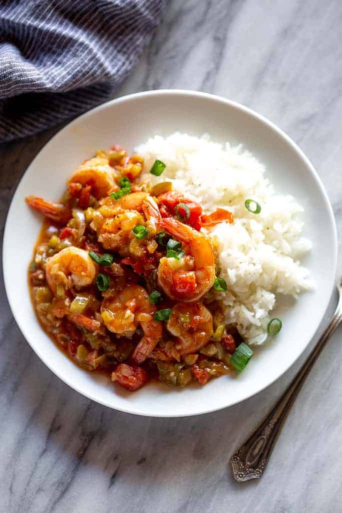 Shrimp creole on a plate with white rice.