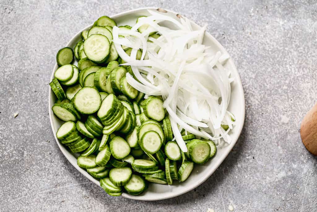 Chopped cucumber and onion on a plate.