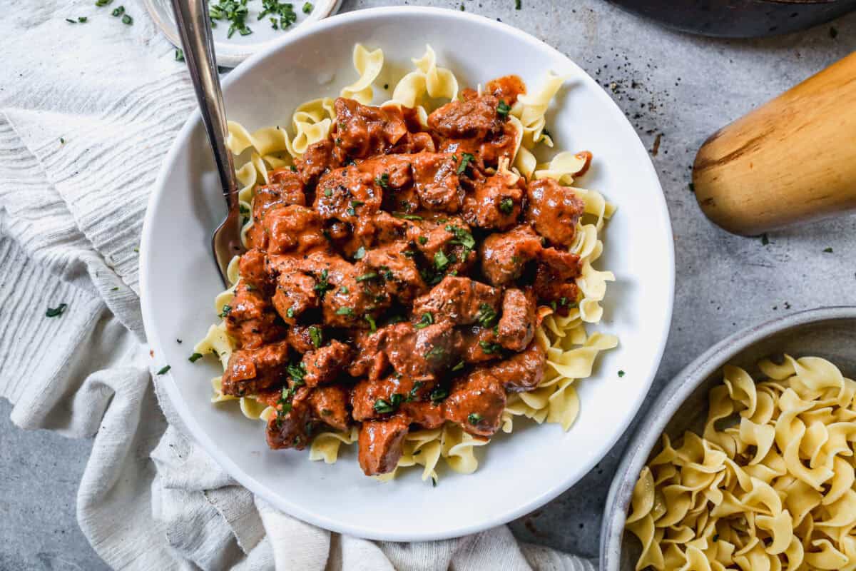 This beef Porkolt recipe is flavorful, hearty, and an excellent comfort meal! I love serving it over homemade egg noodles.