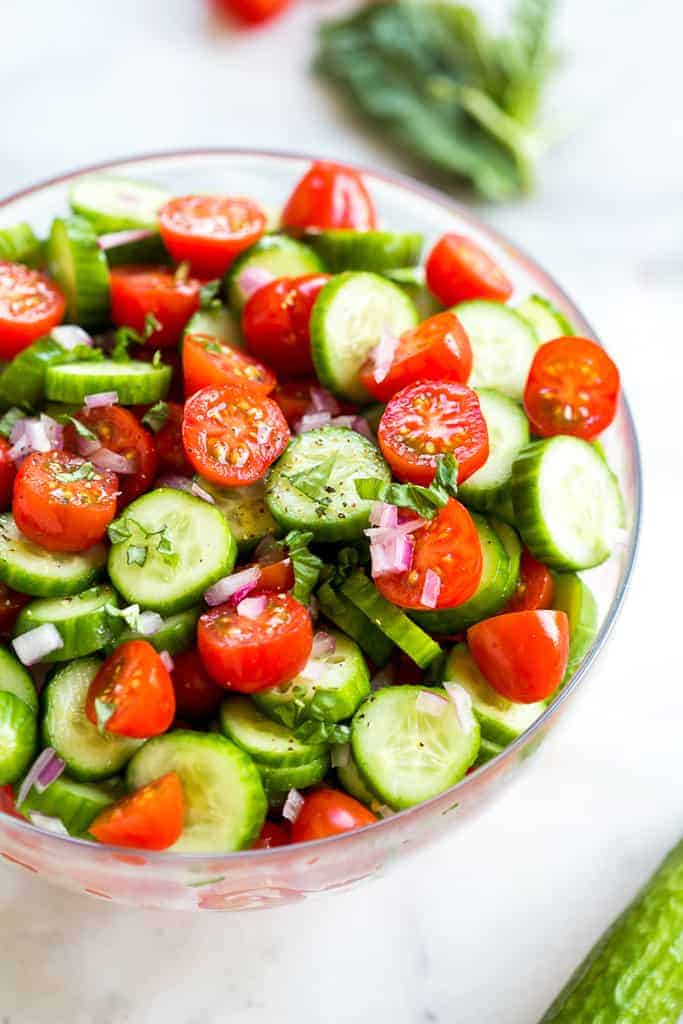 Close up of tomato cucumber salad in a bowl.