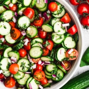 This easy Tomato and Cucumber Salad recipe allows the fresh ingredients to shine with sliced cucumbers, cherry tomatoes, red onion, basil, and oil and vinegar. It is vibrant and delicious and goes with any main dish!