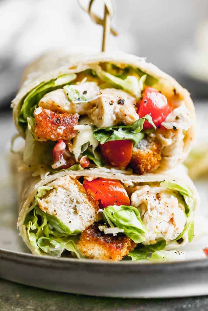 Close up photo of the inside of a chicken caesar wrap.