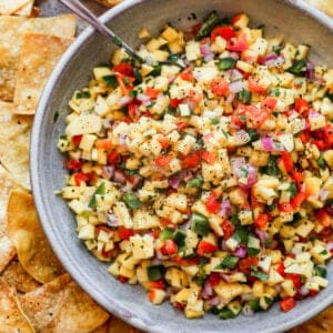A bowl of homemade Mango Salsa with all of the ingredients diced and mixed in a large bowl.