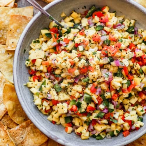 A bowl of homemade Mango Salsa with all of the ingredients diced and mixed in a large bowl.