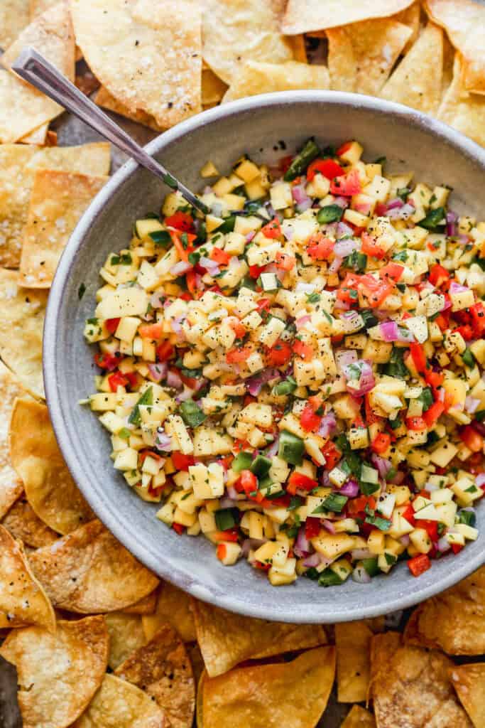 A bowl of homemade Mango Salsa with all of the ingredients diced and mixed in a large bowl.