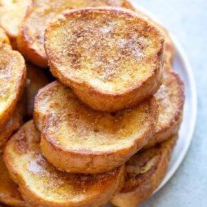 A stack of Torrijas on a white plate.