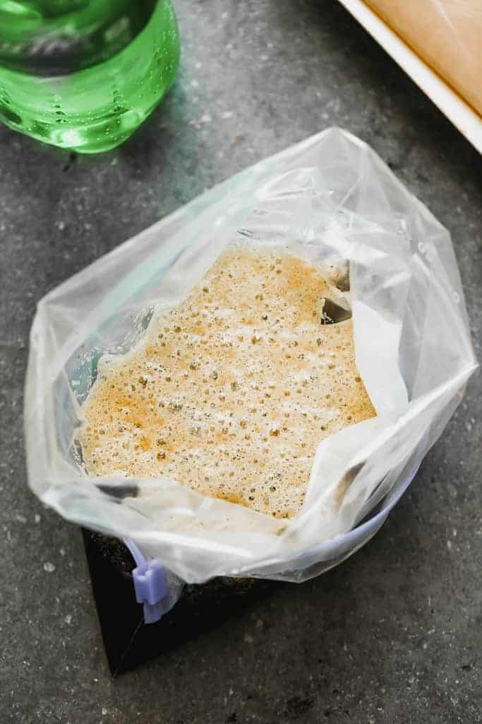 Chicken marinating in a gallon ziplock bag.