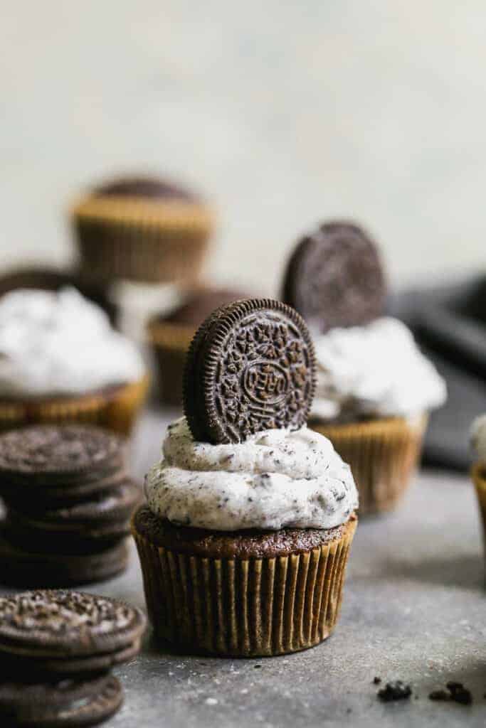 Oreo cupcakes with Oreo frosting and a whole Oreo cupcake pressed into the frosting.