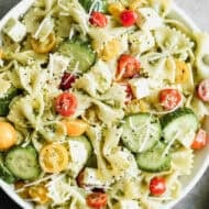 This easy Pesto Pasta Salad recipe has fresh tomatoes, cucumbers, and mozzarella cheese with pesto covered noodles. It's delicious!