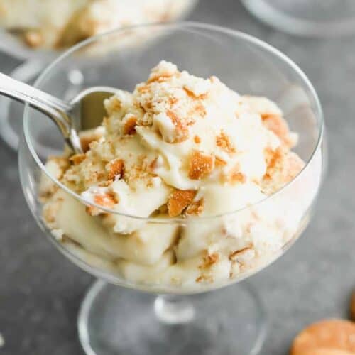 A goblet dessert dish with homemade banana pudding in it.