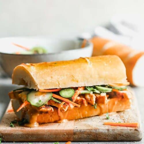 Banh mi sandwich on crusty bread, loaded with chicken, veggies and sauce.