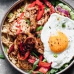 This flavorful Bulgogi Bowls is bold and delicious with a bed of kimchi fried rice, tender marinated pork, peppers, and an egg on top.