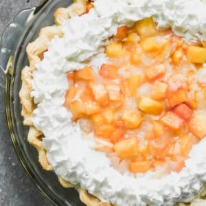 This Fresh Peach Pie recipe is loaded with fresh, juicy peaches and a simple glaze to hold it together in a flaky pie crust. It's the perfect way to take advantage of peach season and always a crowd pleaser!