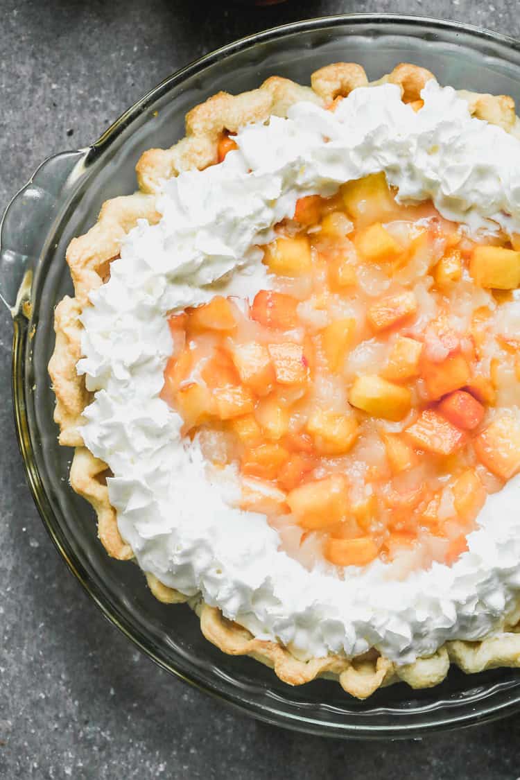 This Fresh Peach Pie recipe is loaded with fresh, juicy peaches and a simple glaze to hold it together in a flaky pie crust. It's the perfect way to take advantage of peach season and always a crowd pleaser!